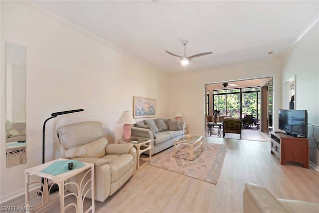 living room with ceiling fan, light wood-type flooring, and crown molding