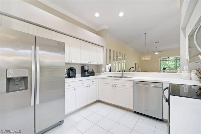 kitchen featuring hanging light fixtures, sink, ceiling fan, appliances with stainless steel finishes, and white cabinetry