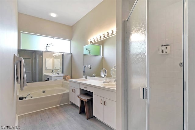 bathroom with vanity, wood-type flooring, and shower with separate bathtub