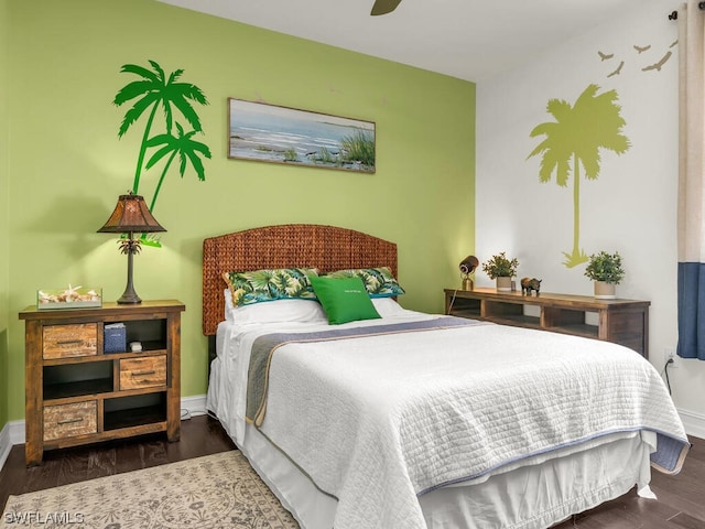 bedroom with dark hardwood / wood-style floors and ceiling fan