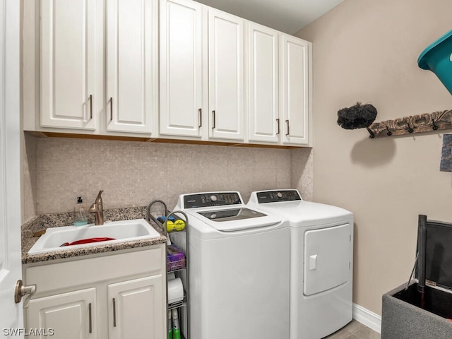 washroom featuring separate washer and dryer, cabinets, and sink