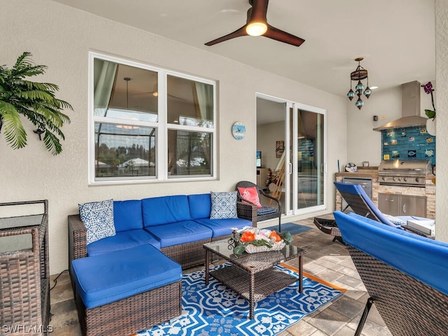 view of terrace with a grill, an outdoor living space, ceiling fan, and exterior kitchen