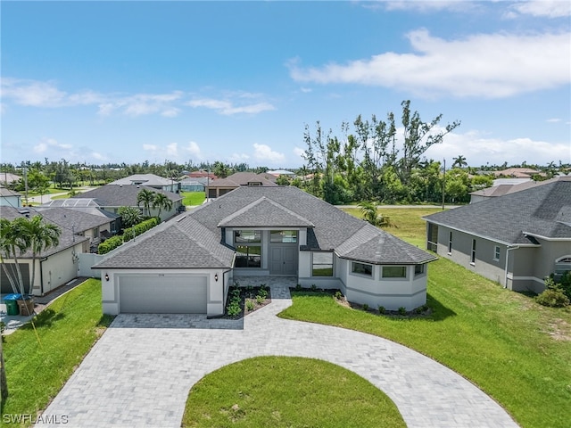 view of front of home with a front yard and a garage