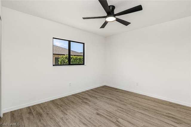 unfurnished room featuring ceiling fan and light wood-type flooring