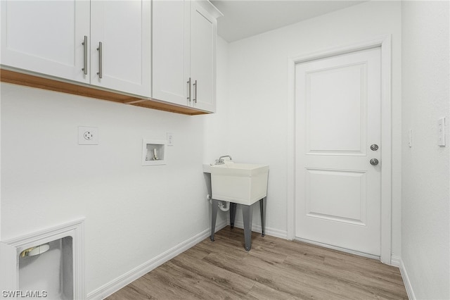 laundry area featuring washer hookup, cabinets, hookup for an electric dryer, and light wood-type flooring