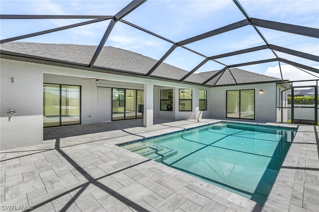 view of swimming pool with a patio, ceiling fan, and a lanai