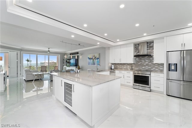 kitchen featuring white cabinets, appliances with stainless steel finishes, wine cooler, and wall chimney exhaust hood