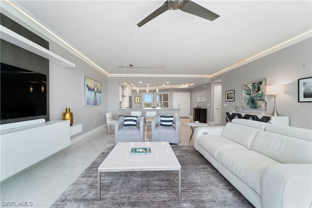 living room with crown molding and ceiling fan with notable chandelier