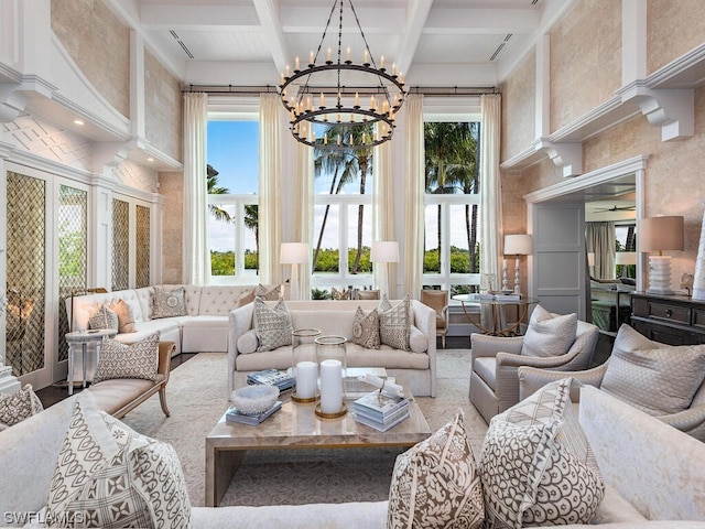 living room featuring beamed ceiling, a high ceiling, coffered ceiling, and an inviting chandelier