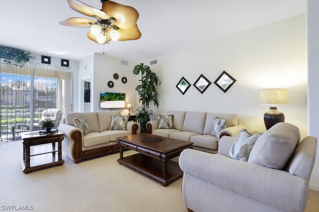 carpeted living room featuring ceiling fan