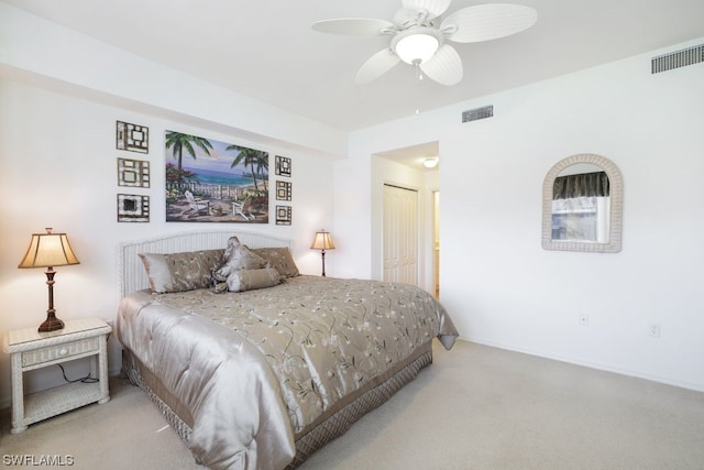 carpeted bedroom with a closet and ceiling fan