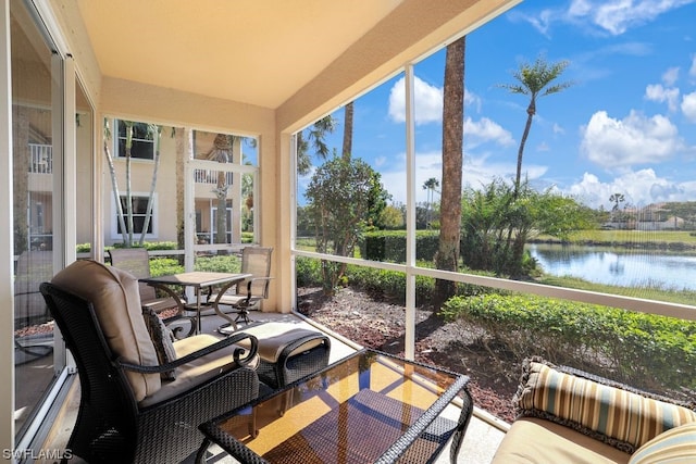 sunroom with a water view and a wealth of natural light