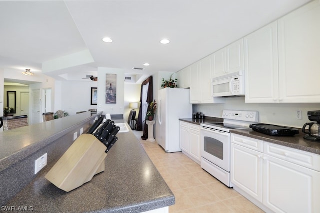 kitchen with white appliances, white cabinetry, and light tile floors