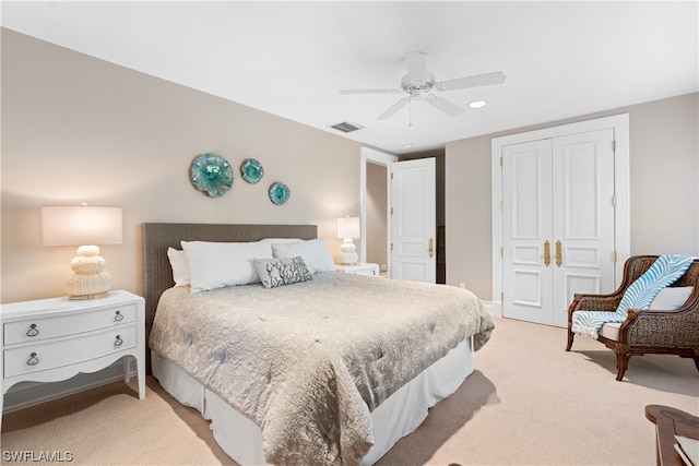 bedroom featuring ceiling fan, a closet, and light carpet