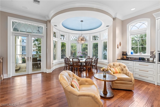 sunroom / solarium featuring french doors and a notable chandelier