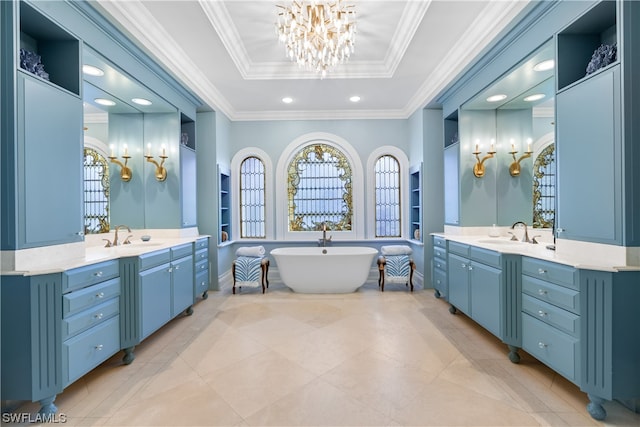 bathroom with a bathing tub, vanity, a tray ceiling, and crown molding