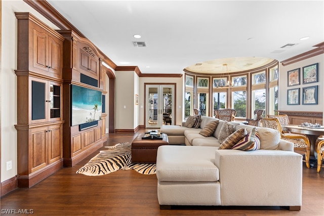 living room with crown molding, french doors, a chandelier, and dark hardwood / wood-style floors