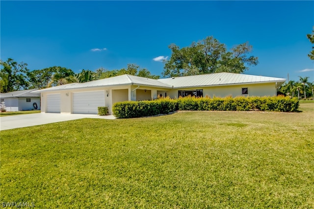 ranch-style house featuring a garage and a front yard