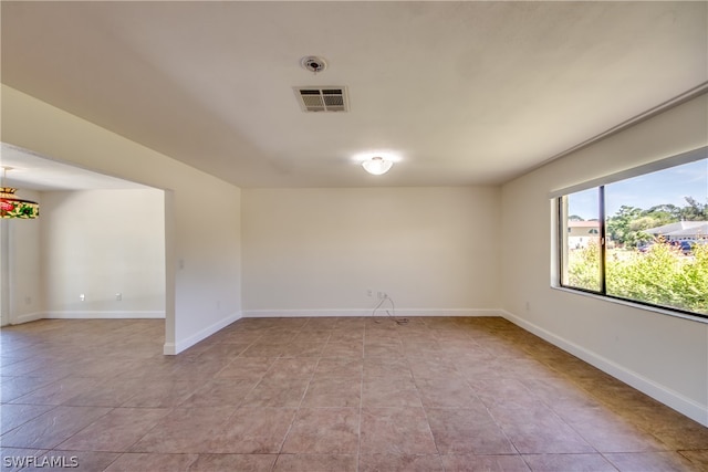 unfurnished room with tile flooring