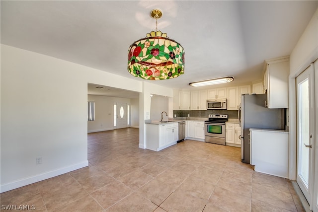 kitchen featuring appliances with stainless steel finishes, tasteful backsplash, white cabinets, sink, and light tile floors