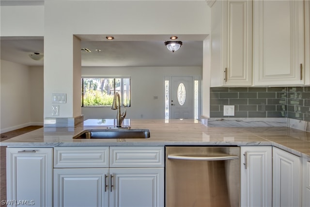 kitchen featuring white cabinetry, backsplash, sink, light stone counters, and dishwasher