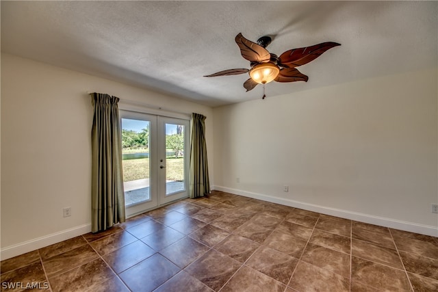 tiled empty room featuring french doors, ceiling fan, and a textured ceiling