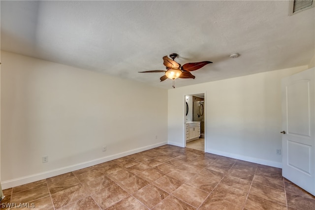 tiled spare room featuring ceiling fan