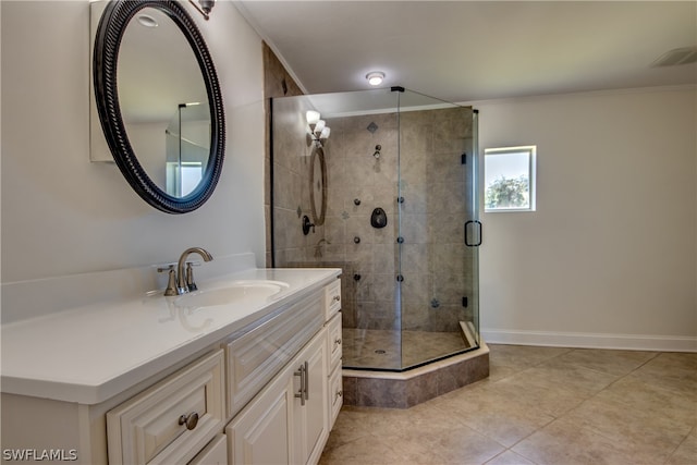 bathroom with an enclosed shower, vanity, and tile flooring