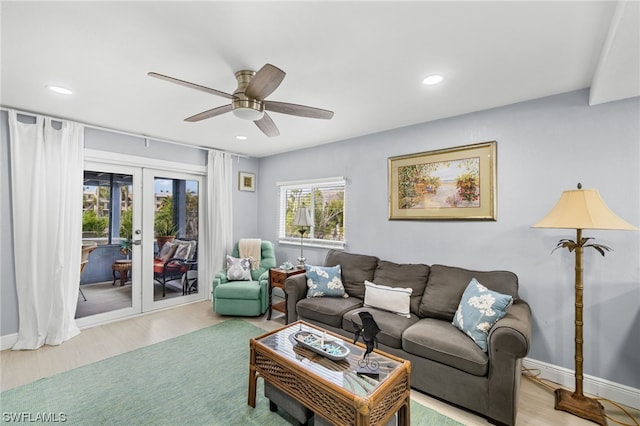 living room with ceiling fan, french doors, and light wood-type flooring