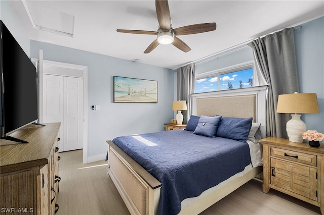 bedroom with light hardwood / wood-style floors and ceiling fan