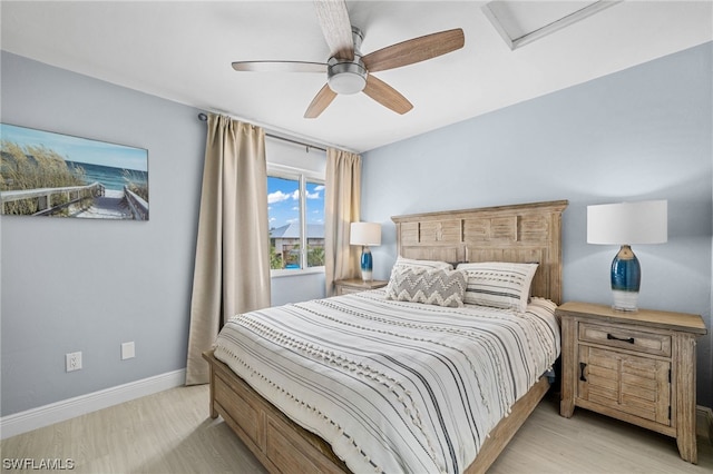 bedroom with ceiling fan and light hardwood / wood-style flooring