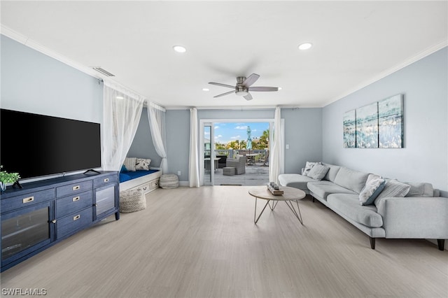 living room with crown molding, ceiling fan, and light wood-type flooring