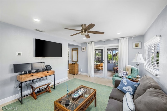 living room with a healthy amount of sunlight, ceiling fan, and french doors