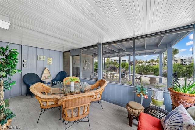 sunroom featuring wood ceiling