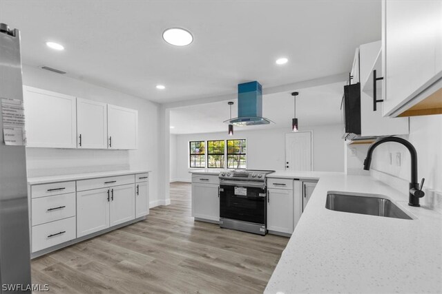 kitchen featuring stainless steel appliances, island range hood, white cabinetry, and light wood-type flooring