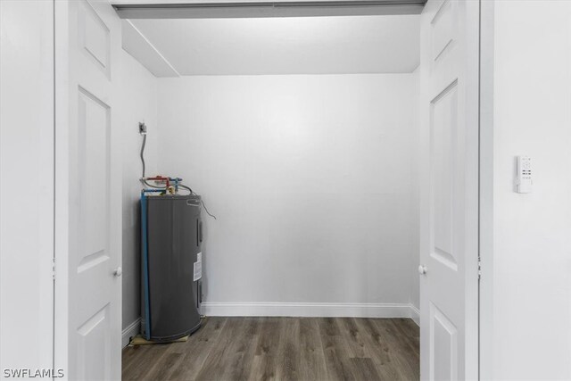 interior space featuring dark wood-type flooring and electric water heater