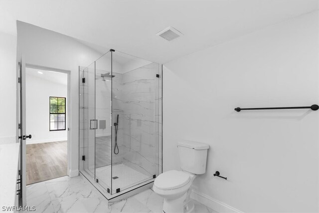 bathroom with tile flooring, an enclosed shower, and toilet