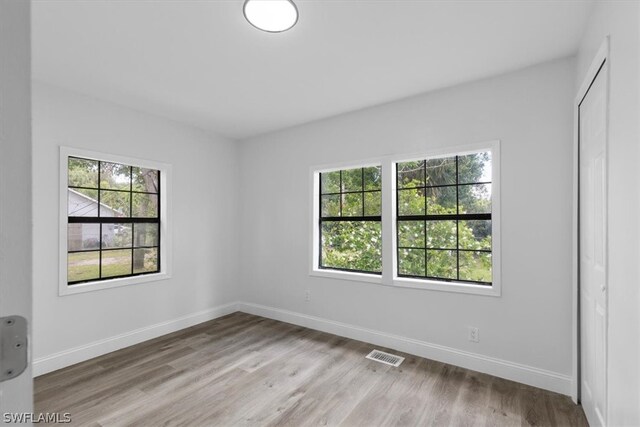 spare room featuring hardwood / wood-style flooring