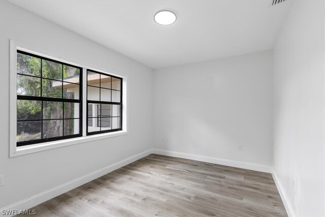 spare room featuring light hardwood / wood-style flooring