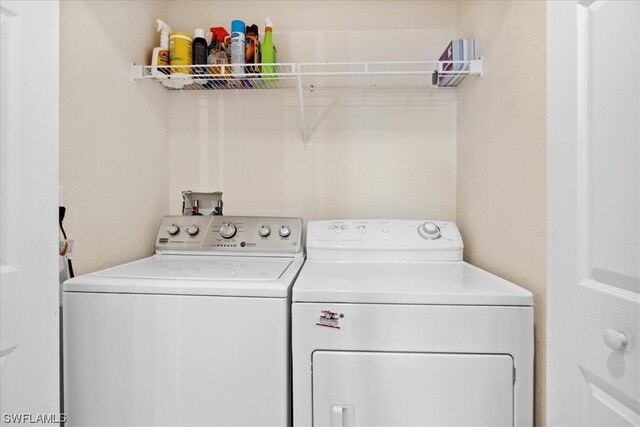 laundry room featuring hookup for a washing machine and washing machine and dryer