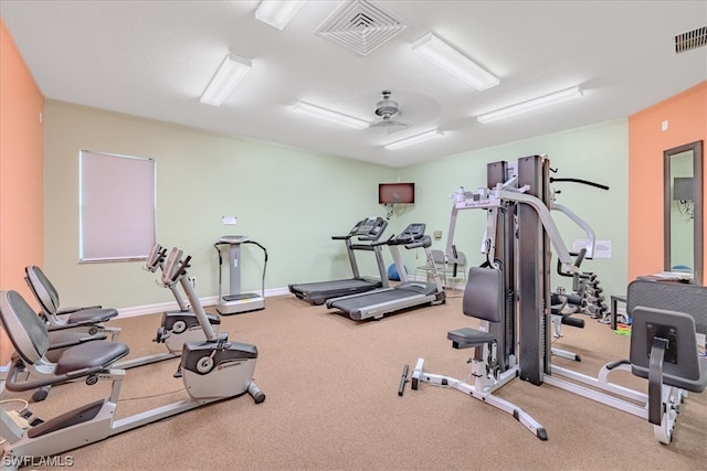 gym with light colored carpet and ceiling fan