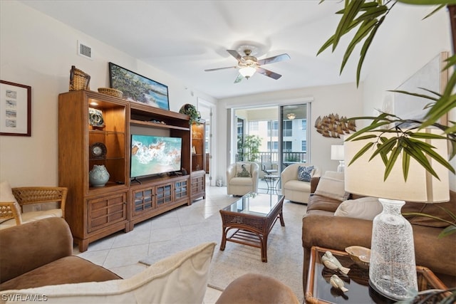 tiled living room with ceiling fan