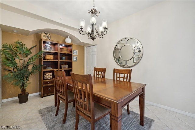 dining room featuring light tile floors and a notable chandelier