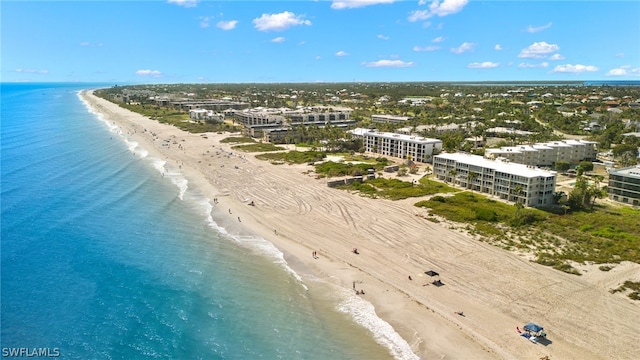 drone / aerial view featuring a water view and a view of the beach