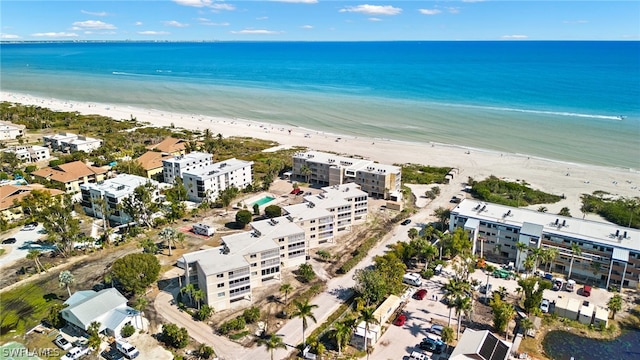 birds eye view of property featuring a beach view and a water view