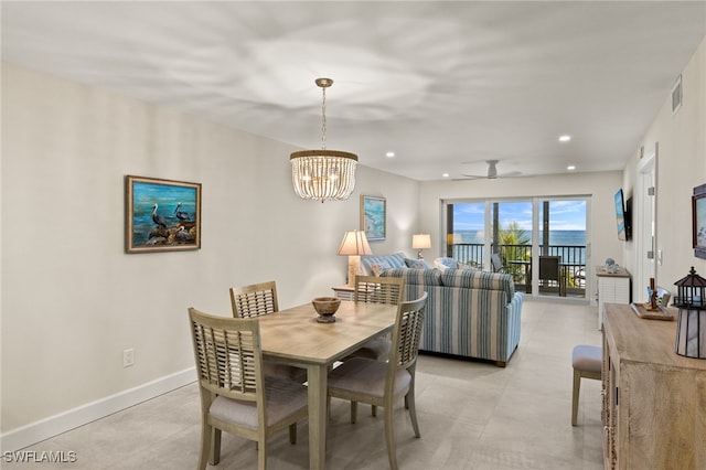 dining room featuring ceiling fan with notable chandelier