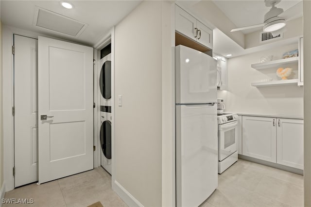 washroom with stacked washer and dryer, light tile patterned floors, and ceiling fan