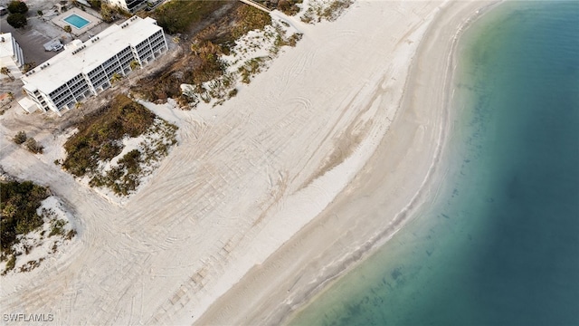 drone / aerial view featuring a water view and a beach view