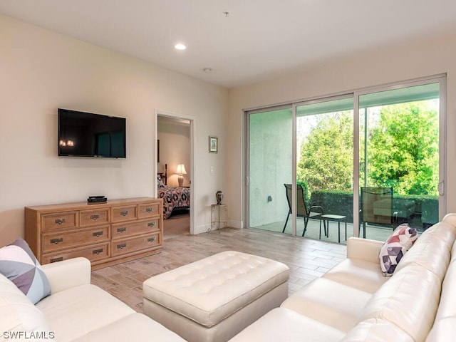 living area featuring light wood-style floors and recessed lighting