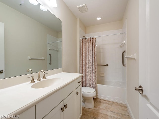 bathroom featuring shower / tub combo with curtain, visible vents, toilet, vanity, and wood finished floors